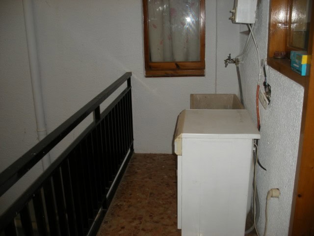 Laundry space with washing machine and utility area in Cuevas del Campo, Granada.