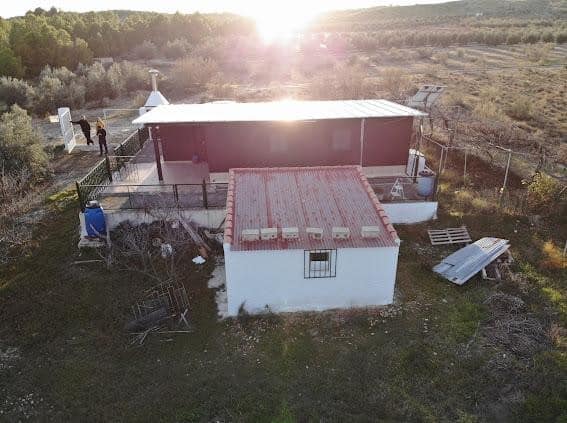 Charming log home situated in Freila, Granada, with scenic rural surroundings and outdoor living spa.