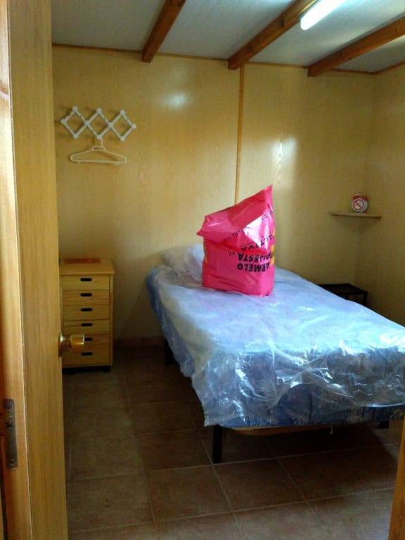 Log Home Bedroom with Simple Interior in Freila, Granada.