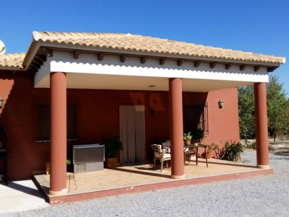 Traditional rural house with porch and outdoor seating in Tijola, Almeria, Spain.
