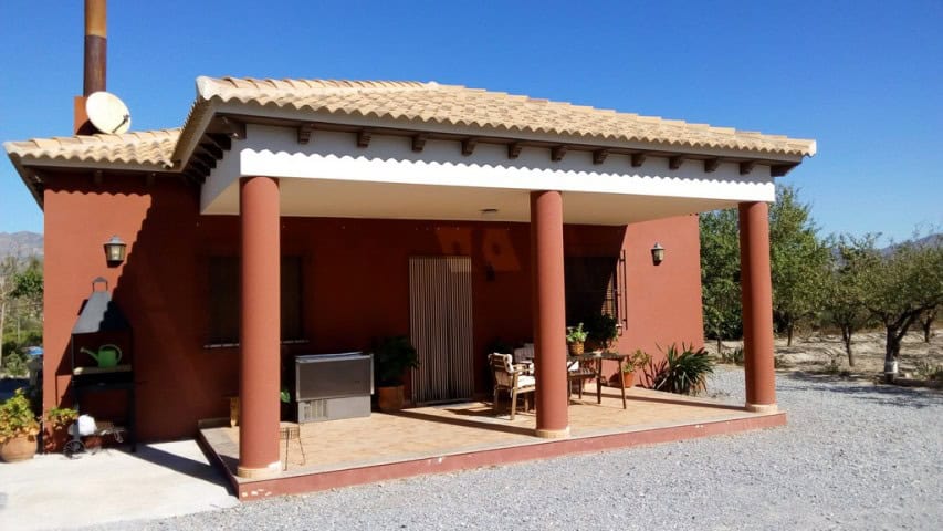 Traditional rural house with porch and outdoor seating in Tijola, Almeria, Spain.