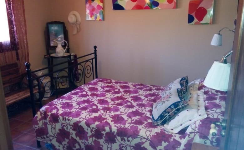 Beautiful rural home in Tijola, Almeria, featuring a cozy bedroom with vibrant decor and traditional.