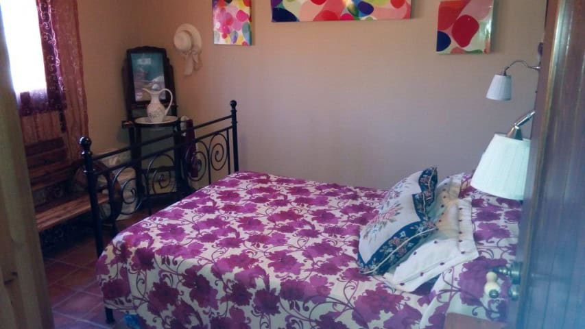 Beautiful rural home in Tijola, Almeria, featuring a cozy bedroom with vibrant decor and traditional.