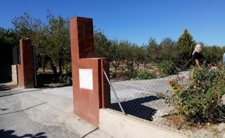 Rural property entrance in Tijola, Almeria with garden and gate.