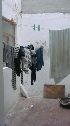 Clothes hanging on a line in a rustic outdoor space in Baza, Granada.