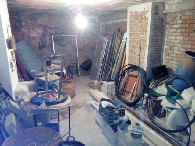 Interior of a rustic village property in Rosales, Jaen, showing construction materials and tools.