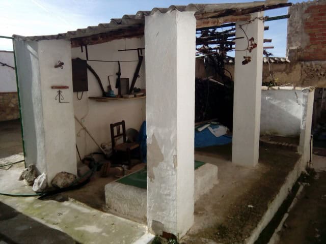 Village property with rustic charm in Rosales, Jaen, featuring simple interior and outdoor space. Id.