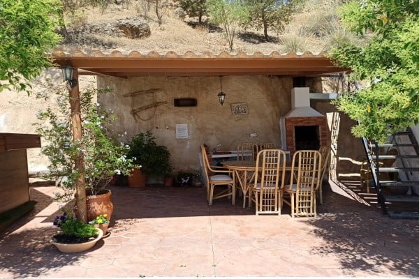 Cave House in Fontanar, Jaen with outdoor patio, dining space, and natural stone walls.