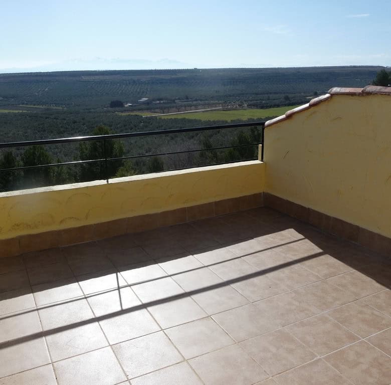 Charming cave house terrace with scenic views of Fontanar, Jaen countryside.