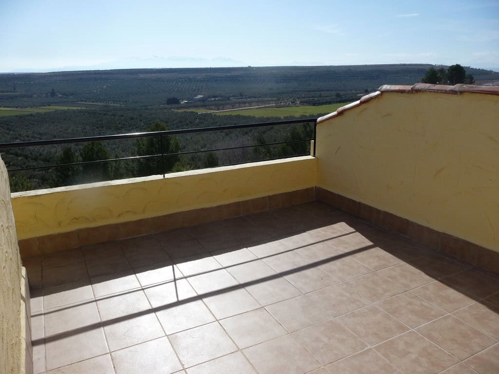 Charming cave house terrace with scenic views of Fontanar, Jaen countryside.