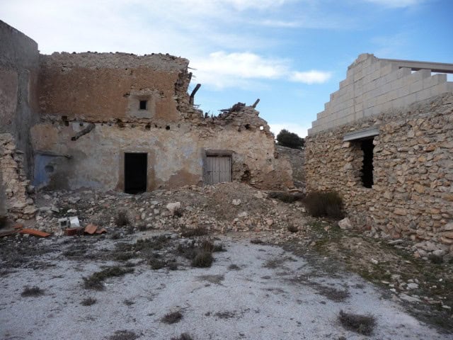 Ruin in Cullar, Granada with old stone walls and damaged structure.
