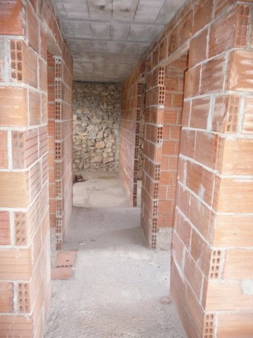 Ruin in Cullar, Granada with brick walls and stone interior.