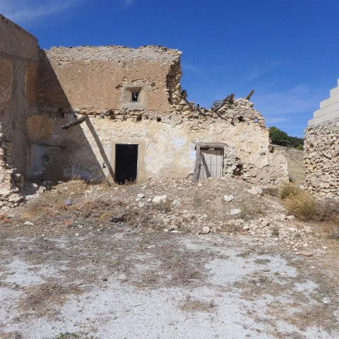 Ancient stone ruin in Cullar, Granada, showcasing historic architecture and scenic rural surrounding.