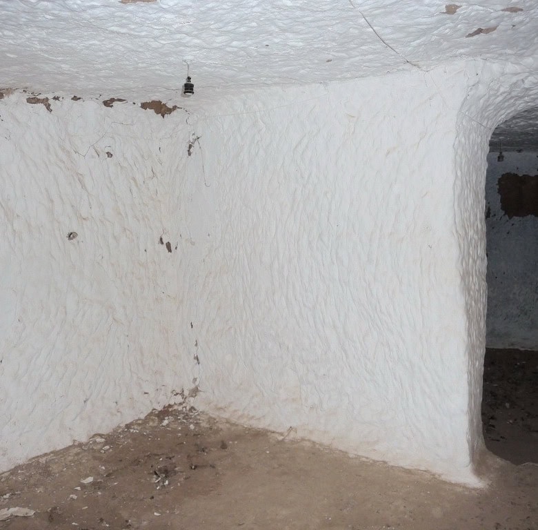 Cave house interior in Freila, Granada, showcasing traditional whitewashed walls and unique undergro.