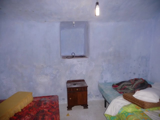 Cave house interior in Freila, Granada with rustic furniture and simple decor.