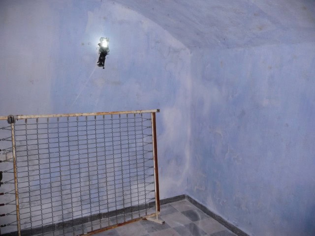 Cave house interior with blue walls and minimal lighting in Freila, Granada. Unique living space car.