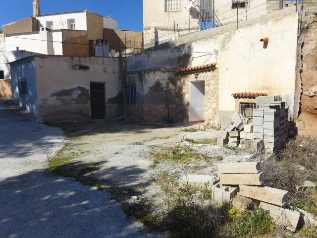 Cave house in Freila, Granada, with rustic walls and outdoor space, offering a unique living experie.