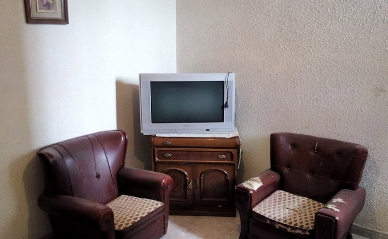 Charming village property in Zujar, Granada, featuring a cozy living room with vintage furniture and.