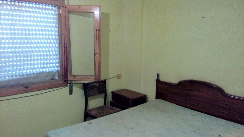 Charming village home in Zujar, Granada with cozy bedroom and traditional decor.