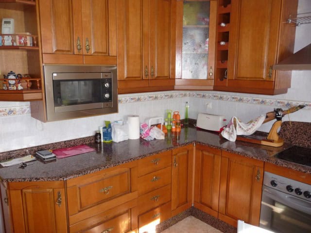 Charming kitchen in a village property in Zujar, Granada, featuring wooden cabinets and modern appli.