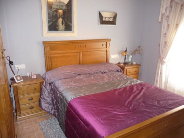Charming bedroom in a village property located in Zujar, Granada, featuring wooden furniture and coz.