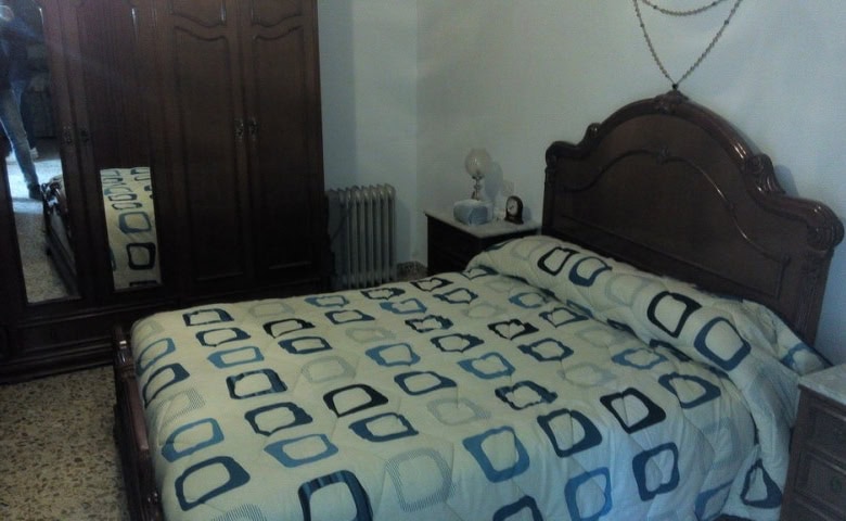 Charming village property in Zujar, Granada, featuring a cozy bedroom with traditional decor and woo.