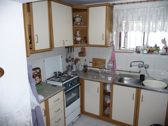 Charming kitchen in a village property in Zujar, Granada, featuring traditional wooden cabinets and.