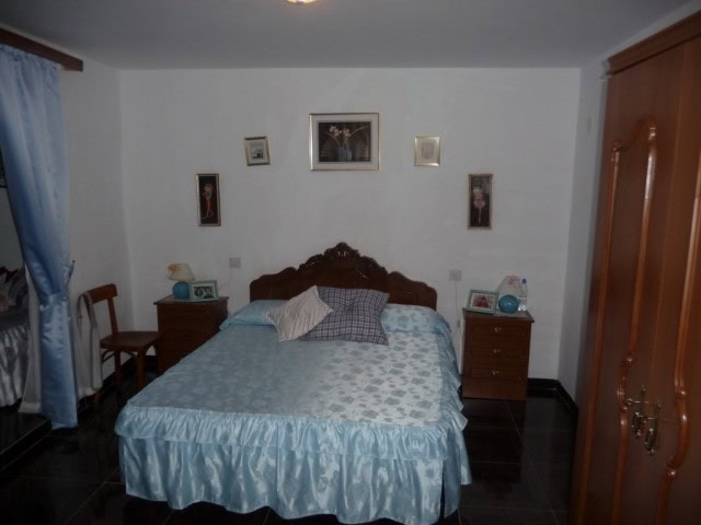 Cozy bedroom in a traditional village property in Zujar, Granada, featuring classic furnishings and.