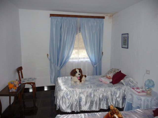 Charming bedroom in Zujar village property with plush toys and cozy decor.