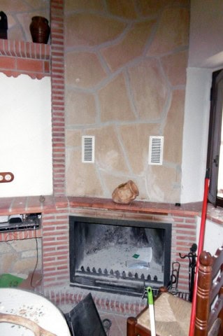 Cozy village house fireplace with rustic decor in Hinojares, Jaen.