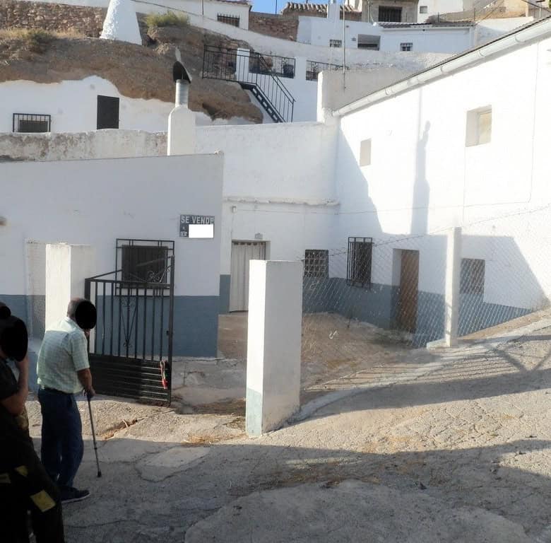 Charming cave house in Freila, Granada, with whitewashed walls and scenic surroundings.
