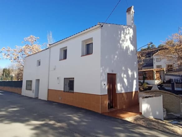 Charming white town house in Fontanar, Jaen, with traditional architecture and scenic surroundings.