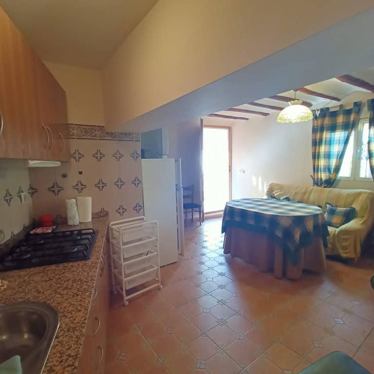 Charming interior of a town house in Fontanar, Jaen, featuring a kitchen and living area with tradit.