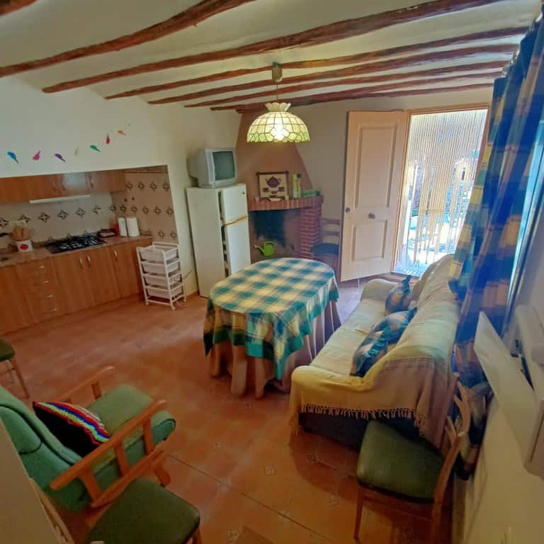 Cozy interior of a town house in Fontanar, Jaen, featuring a living area with a sofa, dining table,.
