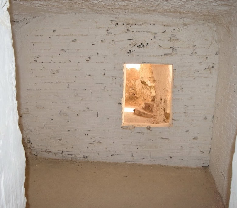 Cave house interior with small window in Cuevas del Campo, Granada, showcasing traditional undergrou.