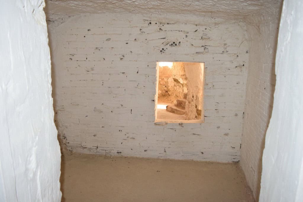 Cave house interior with small window in Cuevas del Campo, Granada, showcasing traditional undergrou.