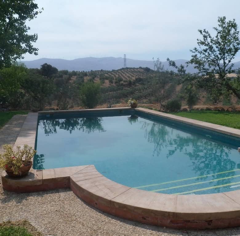 Beautiful outdoor swimming pool with scenic views in Loja, Granada.