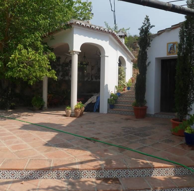 Commercial property in Loja, Granada featuring a charming outdoor patio and vibrant plants.