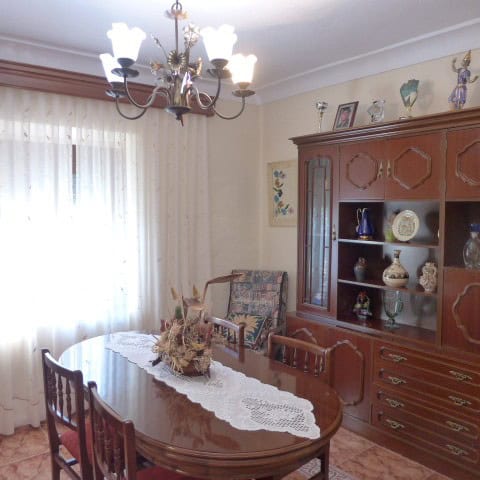 Elegant living room with wooden furniture and decorative items in Fontanar, Jaen.