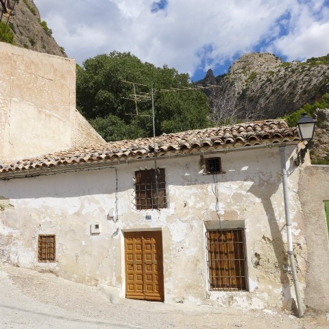 Traditional rural property in Don Pedro, Jaen, featuring rustic walls and wooden window bars.