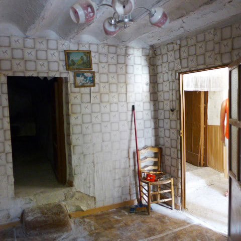 Charming rural home interior in Don Pedro, Jaen with rustic walls and simple furnishings.