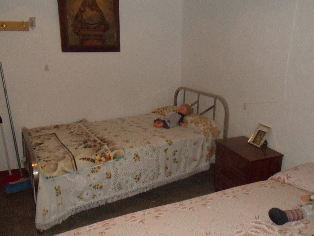 Charming bedroom in a cave house located in Freila, Granada, featuring traditional decor and rustic.