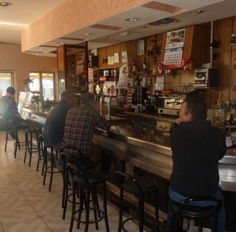 Bar interior with customers enjoying drinks in Cuevas del Campo, Granada.