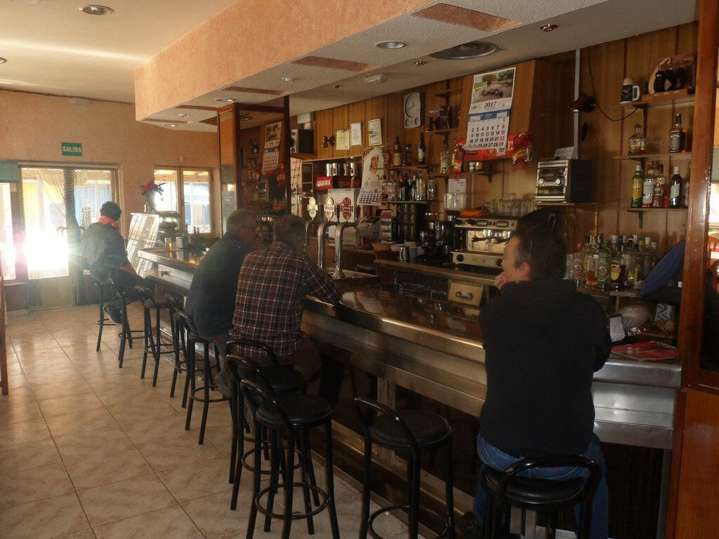 Bar interior with customers enjoying drinks in Cuevas del Campo, Granada.