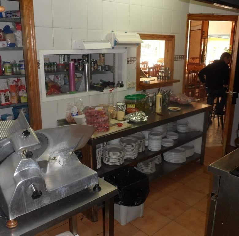 Commercial kitchen with appliances, utensils, and storage in Cuevas del Campo, Granada.
