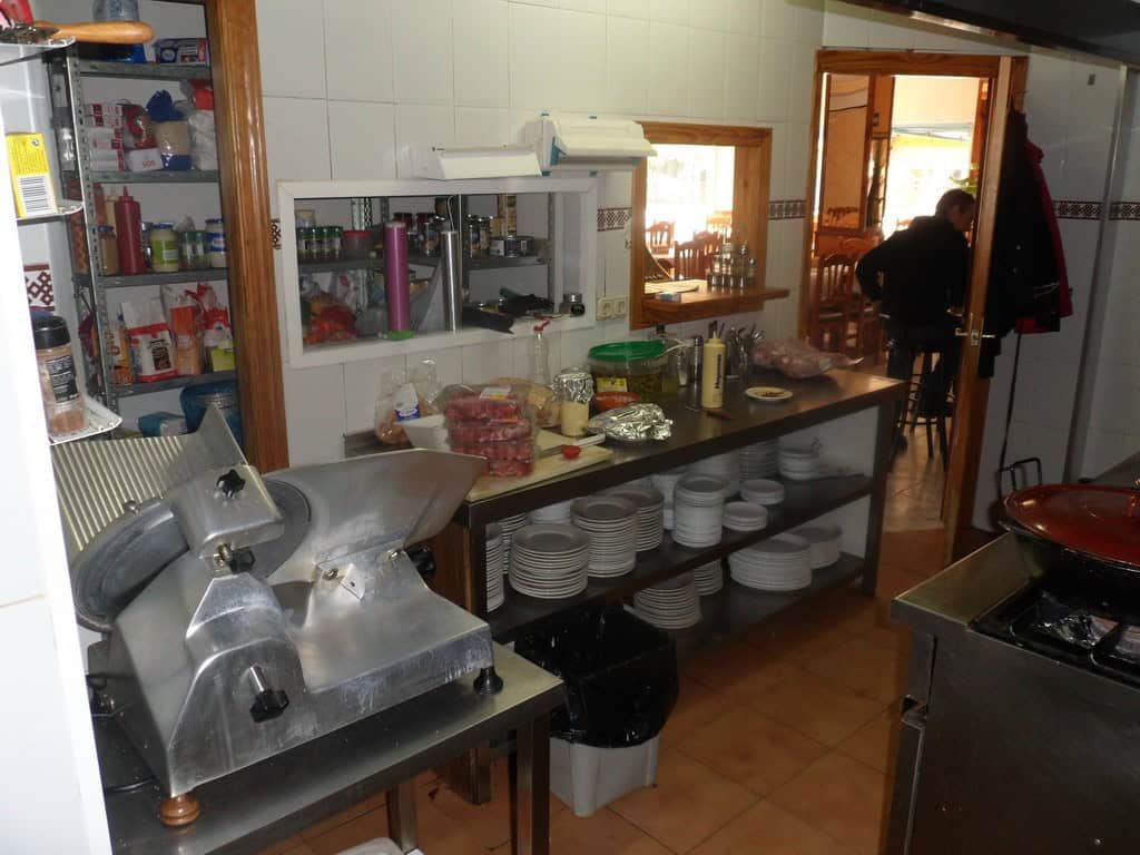Commercial kitchen with appliances, utensils, and storage in Cuevas del Campo, Granada.
