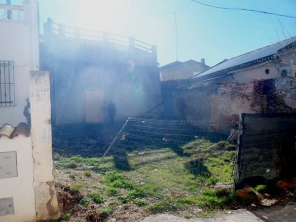 Cave house in Cuevas del Campo, Granada, with rustic exterior and surrounding landscape.