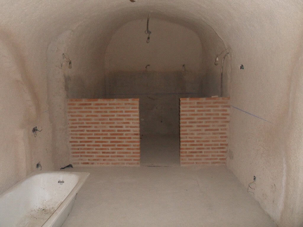 Traditional cave house interior with brick partitions in Cuevas del Campo, Granada.