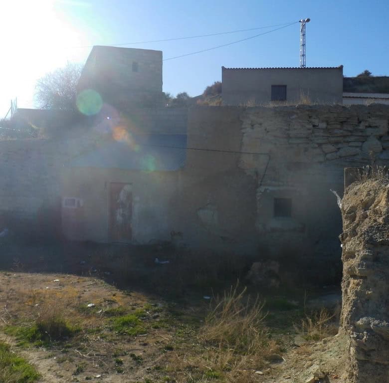 Cave house in Benamaurel, Granada, with traditional stone walls and rustic charm.