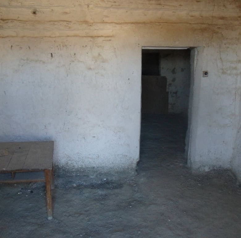Cave house interior with rustic walls and doorway in Benamaurel, Granada. Ideal for renovation or un.